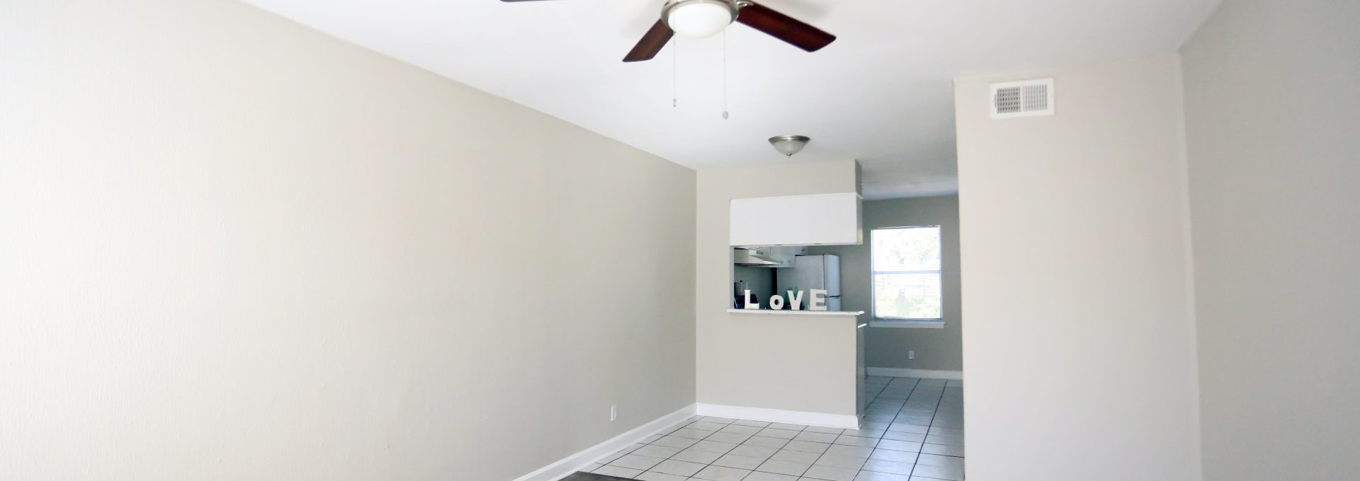 empty room with ceiling fan and hardwood floor at The Vista Villa Apartments